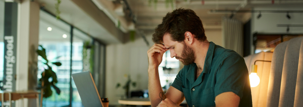 man at computer is stressed