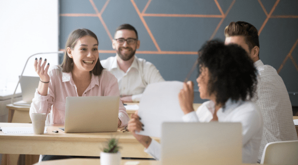 Coworkers talk at table