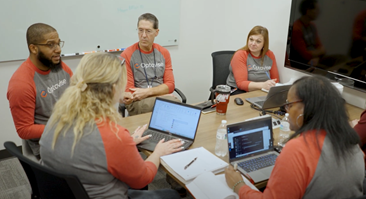 Group of Optavise team members at table