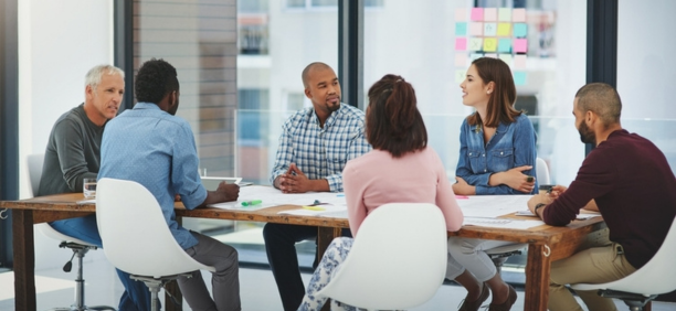 Group of employees at conference table. 