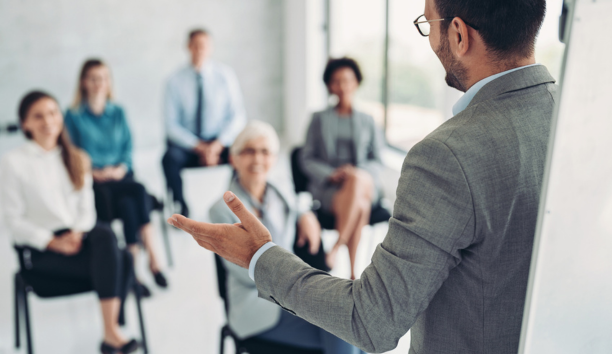 Employer giving a presentation to employees. 