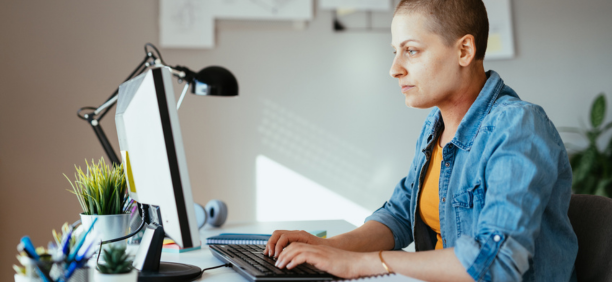 Employee with cancer on her laptop.