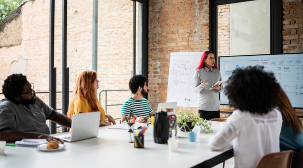 Group of diverse employees working together in a conference room.