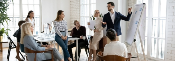 Group of employees of all ages working in a conference room together. 